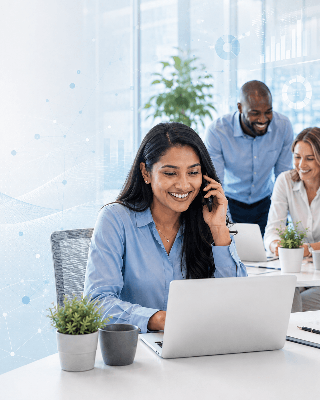 A FundWisr team member on a call with a laptop open, colleagues collaborating in the background